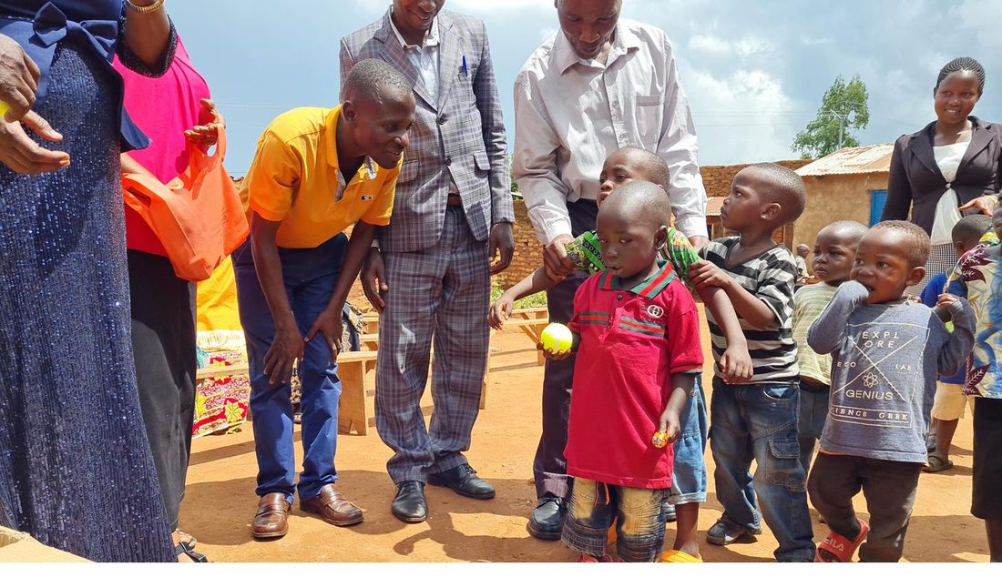 A teacher smiling with a preschool child