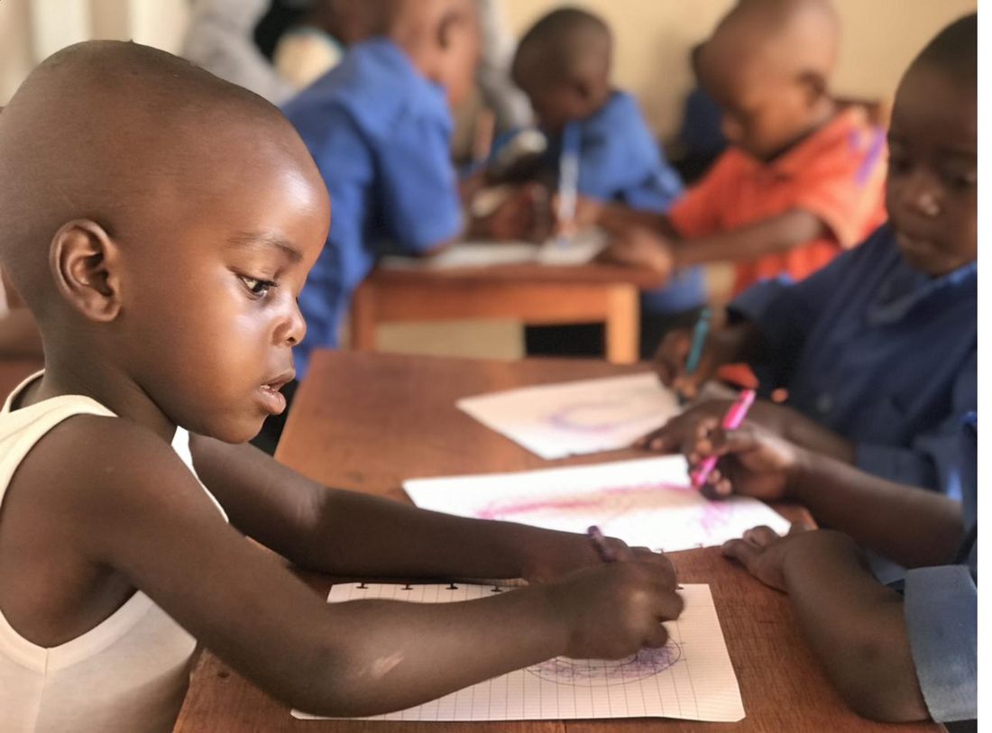 A preschool child writing