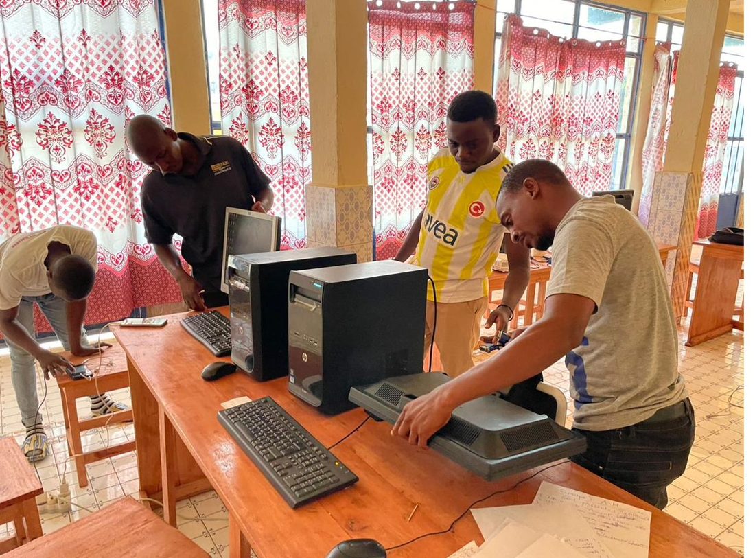 A young person repairing a computer